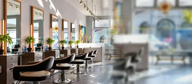 modern hair salon interior with stylist attending a client