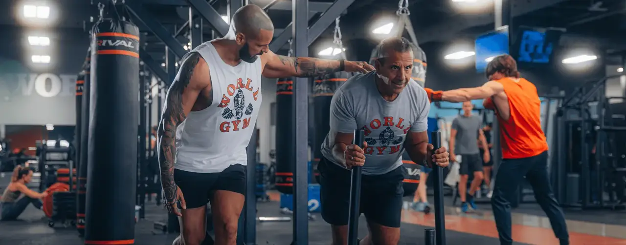 modern gym interior with personal trainer coaching a client