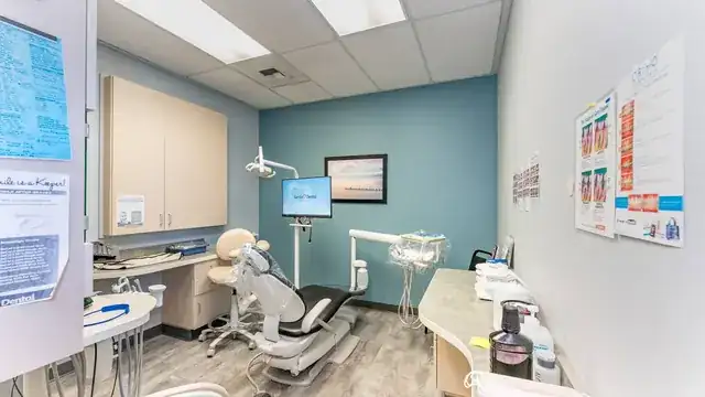 modern dental clinic with dentist treating a smiling patient