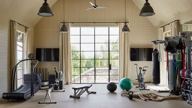 modern gym interior with personal trainer coaching a client