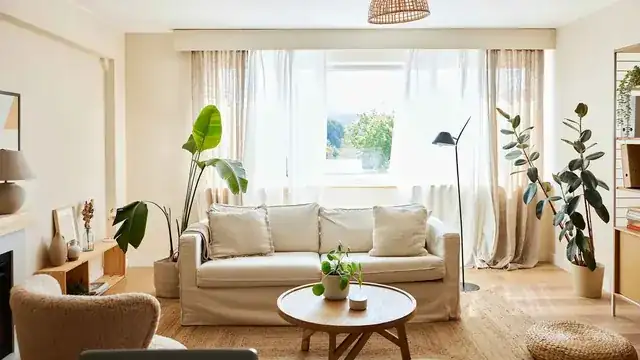 real estate agent showing a bright modern apartment to clients
