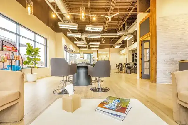 modern hair salon interior with stylist attending a client