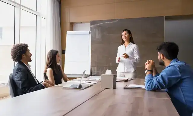 business consultant presenting growth strategy to clients in a meeting room