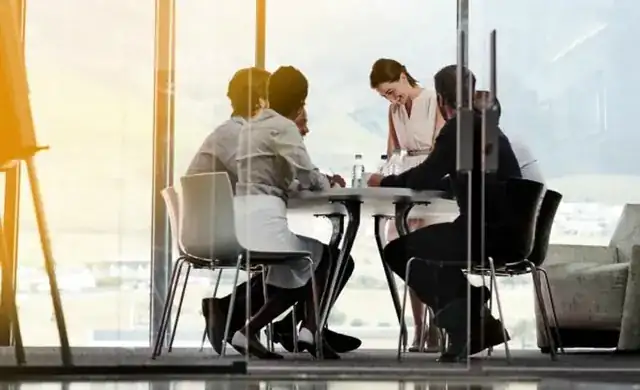 corporate team reviewing B2B website strategy in a glass meeting room