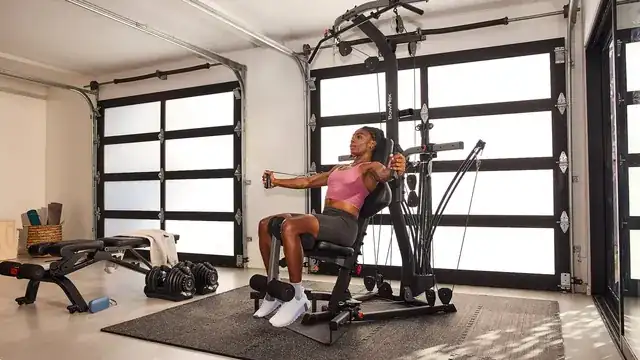 modern gym interior with personal trainer coaching a client