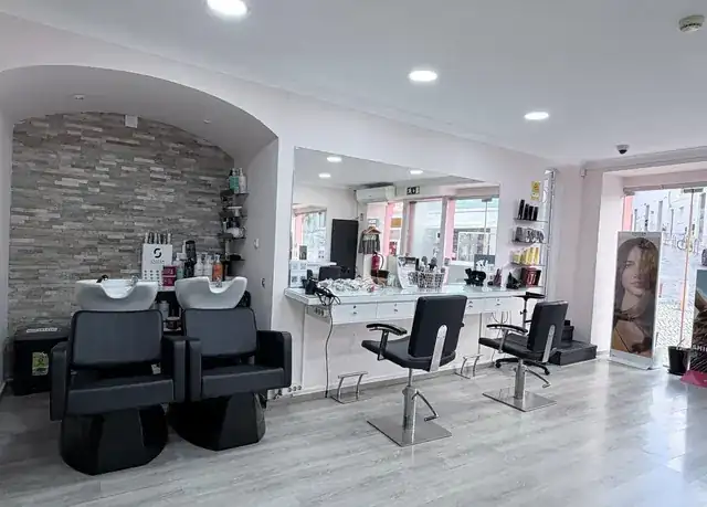 modern hair salon interior with stylist attending a client