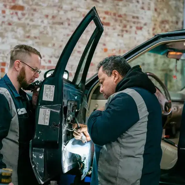 professional mechanic working on a car in a clean modern auto workshop