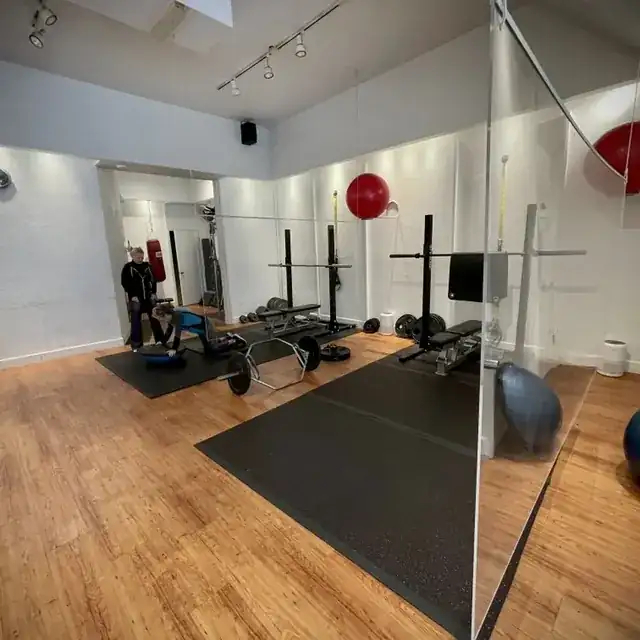 modern gym interior with personal trainer coaching a client