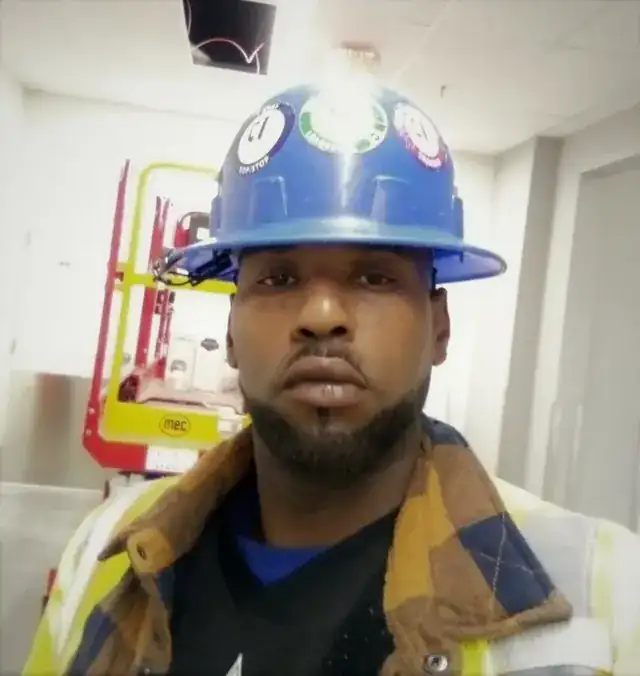 skilled tradesperson with tools working on a professional construction site